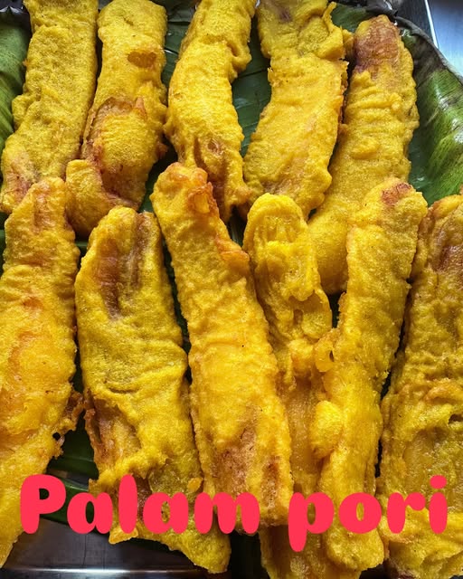 Golden pazham pori (banana fry) on a banana leaf