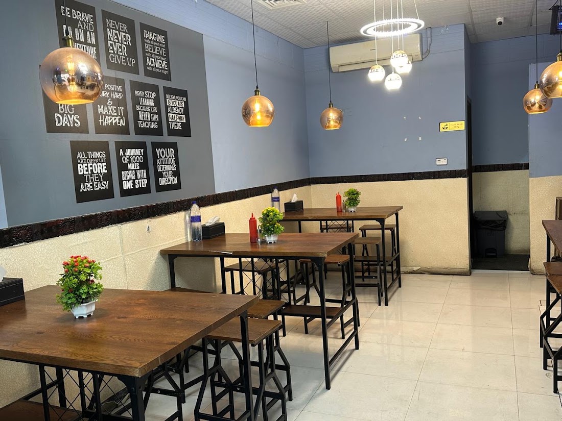 Inside Mumkin: wooden tables and warm copper pendant lights